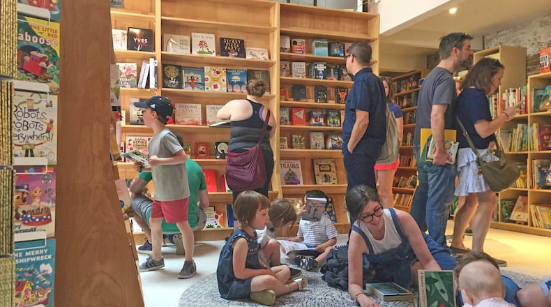 FILE - Customers appear in the children's area of the Books Are Magic bookstore, owned by author Emma Straub, in Brooklyn, New York, on April 29, 2017. (AP Photo/Beth J. Harpaz, File)