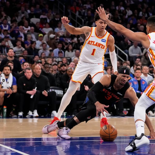 The Hawks’ defense, powered by Jalen Johnson (back) and CJ McCollum, picked up in the fourth quarter, allowing Atlanta to overcome a double-digit deficit in their Game 2 win over the Knicks on Monday, April 20, 2026, at Madison Square Garden in New York. (Yuki Iwamura/AP)