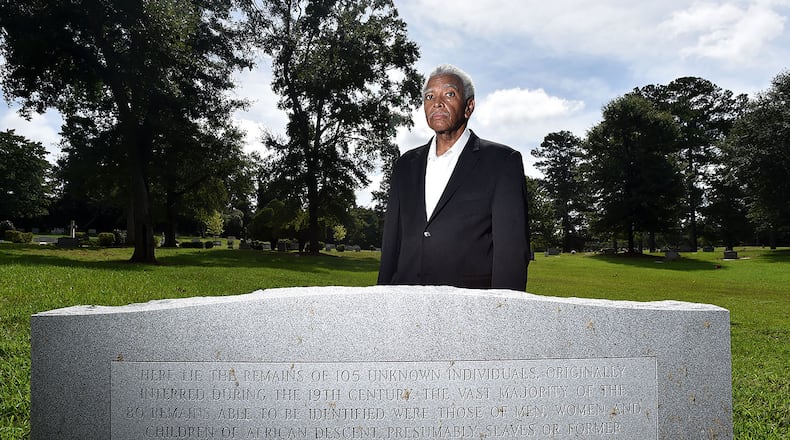 Fred Smith, co-chair of Athens Black History Bowl Committee, stands at a gravestone in Oconee Hill Cemetery in Athens where slave remains once buried on the nearby University of Georgia campus were reinterred in March 2017. Smith, a UGA alumnus, has been urging university officials since the remains were discovered in 2015 to offer a proper memorial that recognizes the slaves and their contributions to the university in its early decades. A granite memorial recognizing the individuals and other slaves is slated to be installed on the front lawn of Baldwin Hall during fall semester.