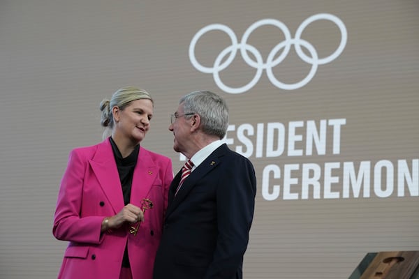 The outgoing IOC President Thomas Bach, right, and the new ICO President Kirsty Coventry talk during the handover ceremony of the IOC Presidency at Olympic House in Lausanne, Switzerland, Monday, June 23, 2025. (AP Photo/Laurent Cipriani)