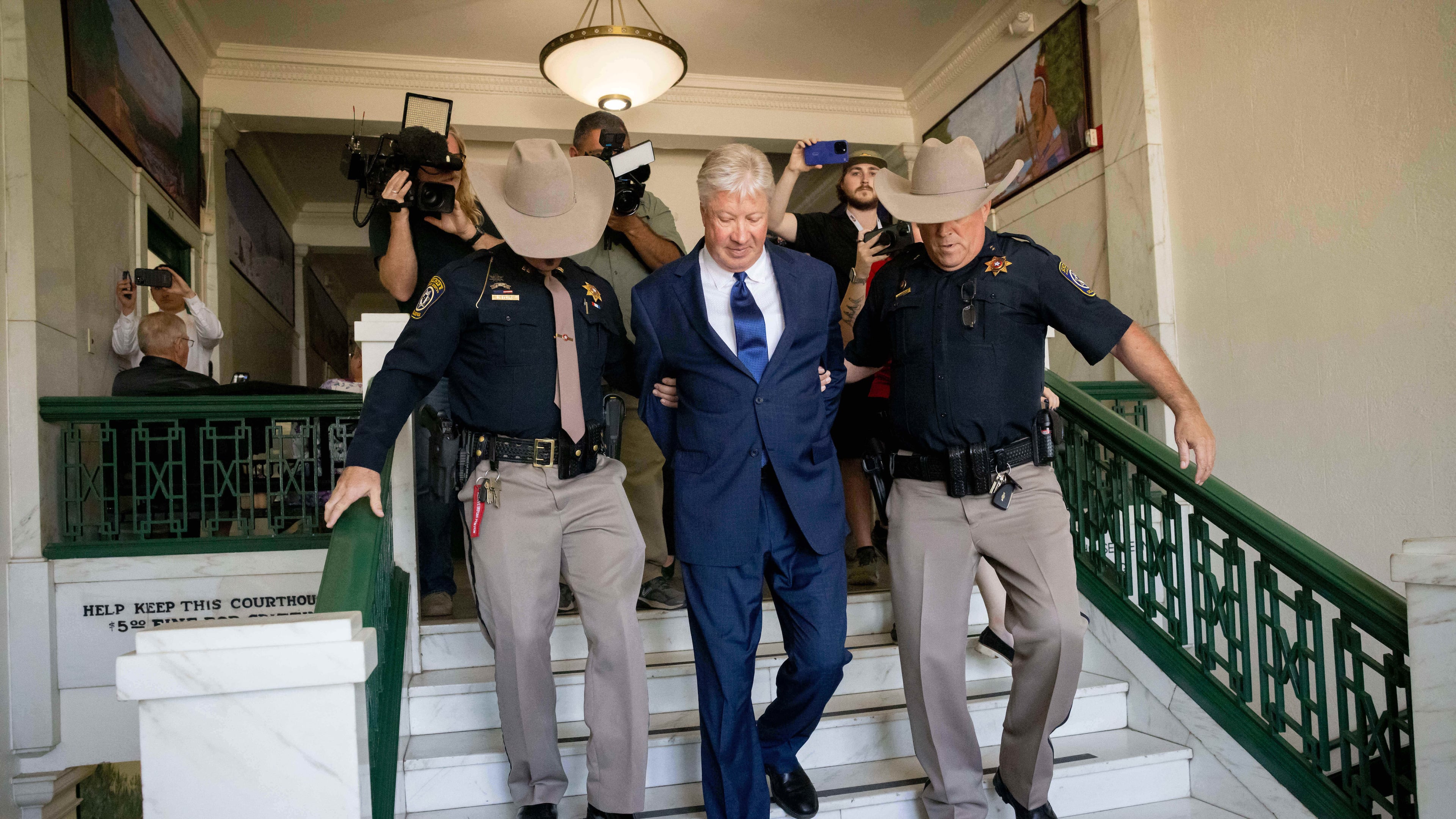 Texas megachurch founder Robert Morris is escorted out of the building after pleading guilty to lewd and indecent acts with a child at the Osage County Courthouse in Pawhuska, Okla., on Thursday, Oct. 2, 2025. (Juan Figueroa/The Dallas Morning News via AP)