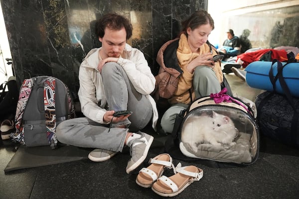 People rest in a metro station, being used as a bomb shelter, during a Russian attack in Kyiv, Ukraine, early Thursday, July 10, 2025. (AP Photo/Efrem Lukatsky)