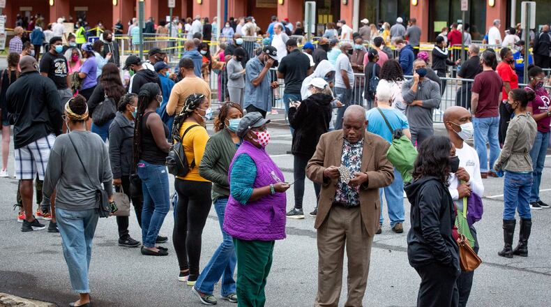 Long lines form outside the Cobb County Board of Elections and Registration offices on Monday for the first day of early voting.  STEVE SCHAEFER / SPECIAL TO THE AJC