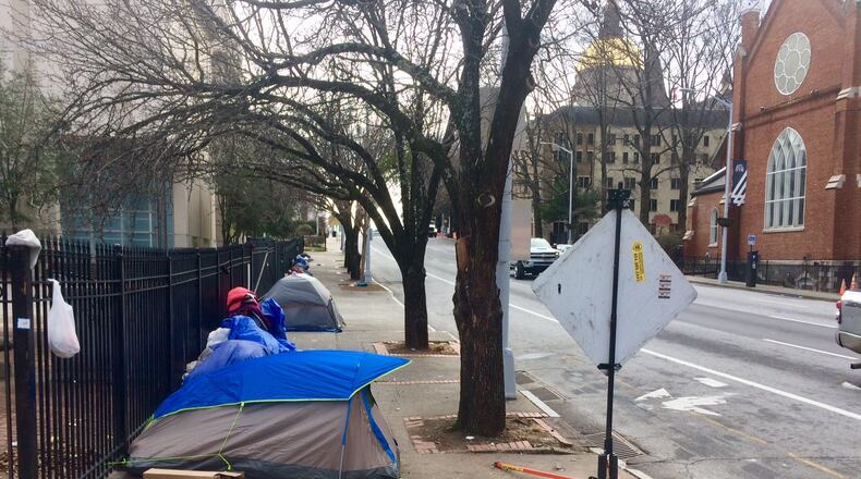 Perhaps a dozen homeless people camp out nightly along Martin Luther King Jr. Drive in Atlanta. Photo by Bill Torpy