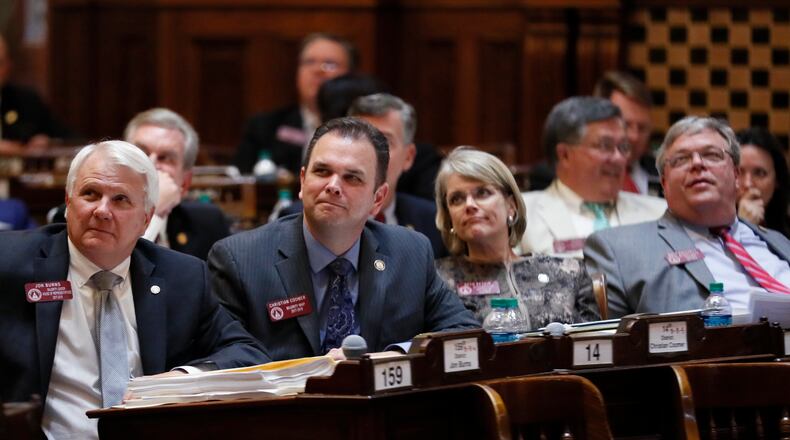 3/27/18 - Atlanta - Rep. Christian Coomer (center) , R - Cartersville, watches the voting for SB 315, relating to computer security, which passed after some debate. At left is House Majority Leader Jon Burns, R - Newington. Today was tthe 39th legislative day, the second to last day of this years General Assembly. BOB ANDRES /BANDRES@AJC.COM
