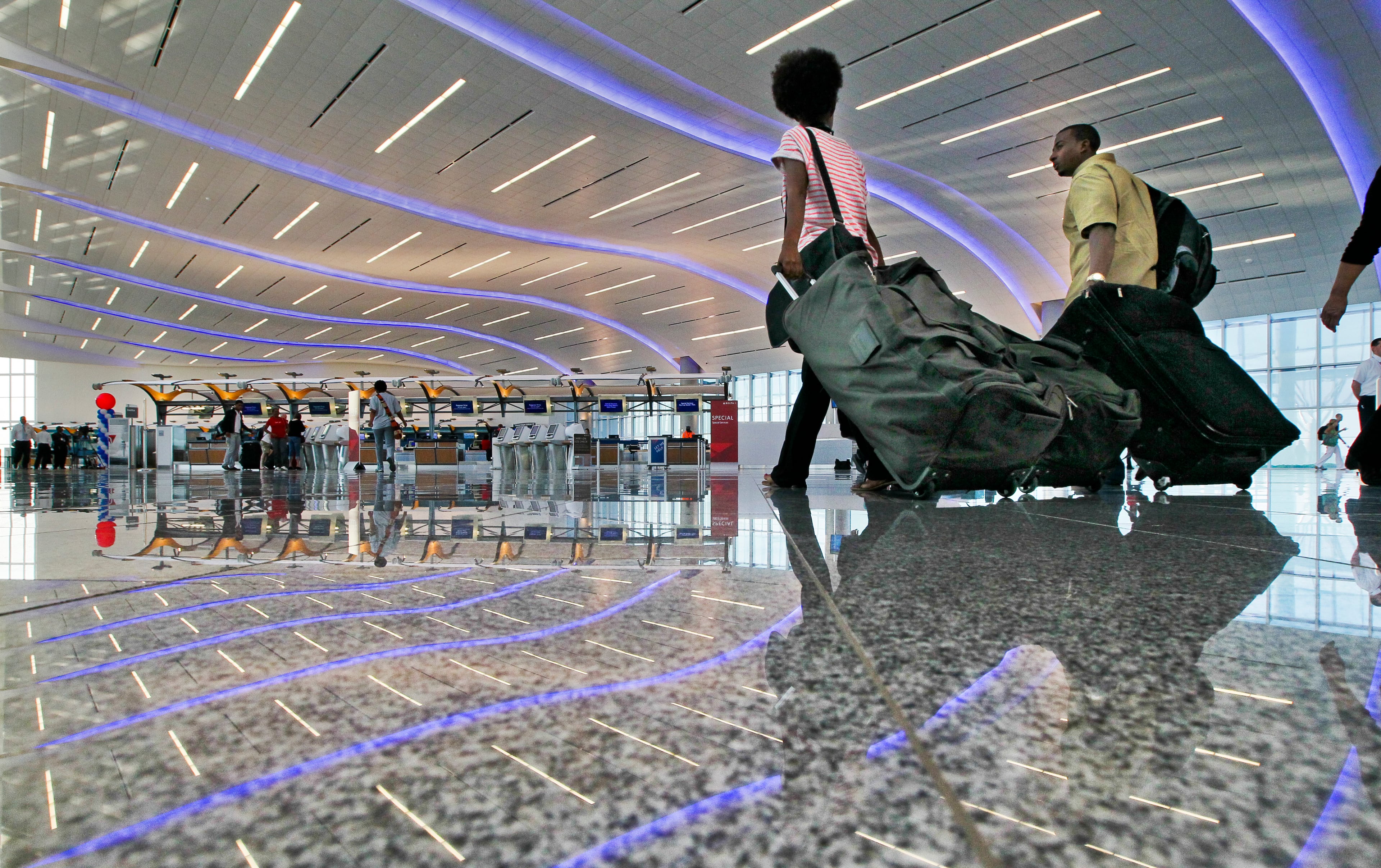 People arrived early in the morning to check in Wednesday, May 16,2012 before the first flight took off from the new international terminal at Hartsfield-Jackson International Airport at 1:25 p.m. The new terminal's price tag exceeded $1.4 billion. (JOHN SPINK / AJC file)