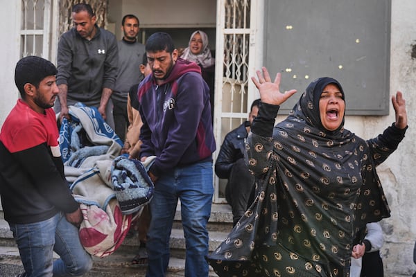 A Palestinian woman reacts as others carry the body of their relative, killed in an Israeli airstrike, in preparation for burial at Shifa Hospital in Gaza City, Wednesday, April 16, 2025. (AP Photo/Jehad Alshrafi)