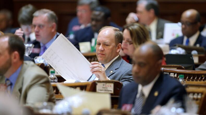 State Rep. Dan Gasaway, R-Homer, flips through the budget as the House listens to a presentation in 2013. Gasaway alleges in a lawsuit filed Thursday that voters in the May 22 GOP primary were given ballots for the wrong district. JASON GETZ / JGETZ@AJC.COM