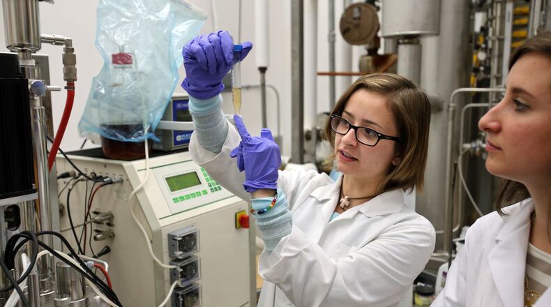 Georgia State University post-doctoral fellow Katie Swensen, center, and research scientist Amber Keller, right, work on research to extend the shelf life of fruits and vegetables in the Applied & Environmental Micro Labs at Georgia State University. AJC FILE PHOTO