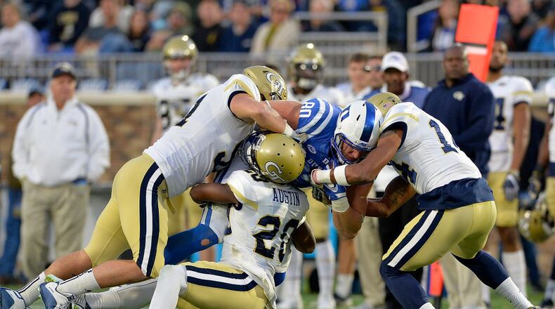 DURHAM, NC - NOVEMBER 18: Kelton Dawson #91, Lawrence Austin #20 and Corey Griffin #14 of the Georgia Tech Yellow Jackets tackle Daniel Helm #80 of the Duke Blue Devils during their game at Wallace Wade Stadium on November 18, 2017 in Durham, North Carolina. (Photo by Grant Halverson/Getty Images)