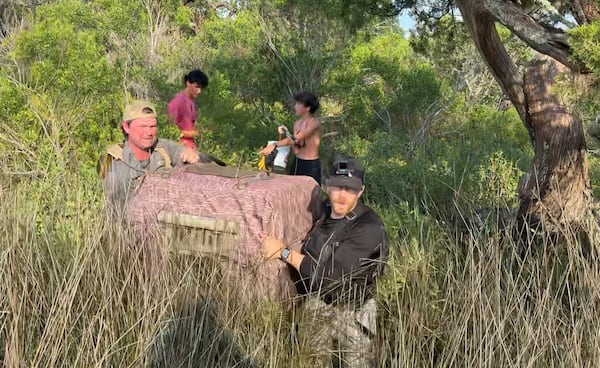 A rescue crew carries Walker in a dog crate from where he was found on Little Tybee Island. The 2-year-old hound spent six days on the uninhabited island after fleeing a house fire. (Photo courtesy of Bryan Donaldson)