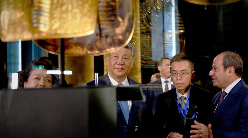 In this photo provided by the Egyptian presidential press office, Chinese President Xi Jinping, center, and Egyptian President Abdel-Fattah el-Sissi, right, tour a gallery displaying the gold funerary mask of Tutankhamun at the Grand Egyptian Museum in Giza, Egypt, Wednesday, Sept. 2, 2026. (Egyptian Presidential Press Office via AP)