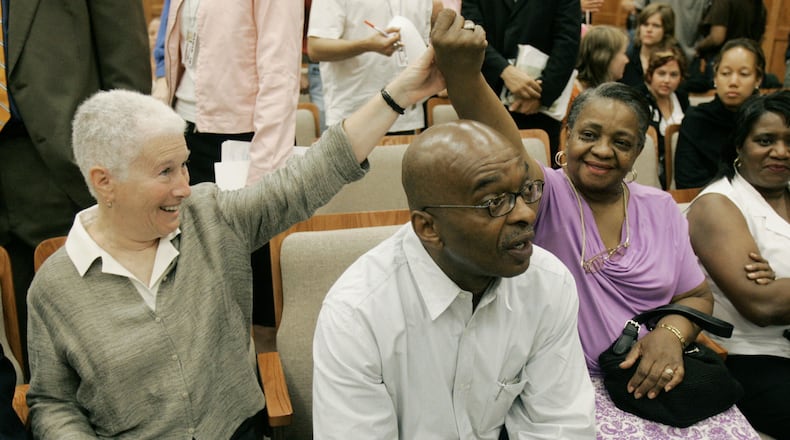 Rita Bender (left), widow of the slain Michael Schwerner, greets Barbara Chaney Dailey, whose brother James Chaney was killed in the same incident. At center is brother Ben Chaney. (AP Photo/Rogelio Solis)