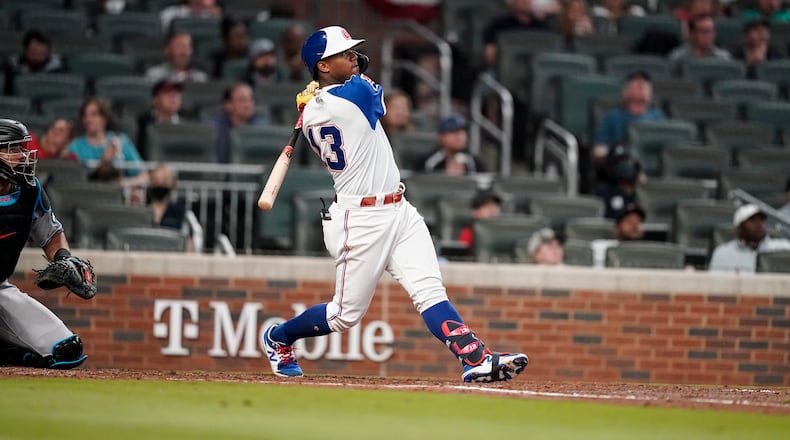 Atlanta Braves' Ronald Acuna Jr., hits a home run in the third inning of a baseball game against the Miami Marlins Wednesday, April 14, 2021, in Atlanta. (AP Photo/Brynn Anderson)