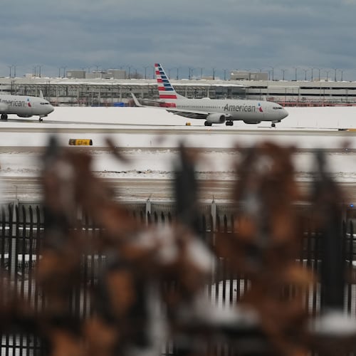 American Airlines planes taxi to terminals at the O'Hare International Airport in Chicago, Sunday, Nov. 30, 2025. (AP Photo/Nam Y. Huh)