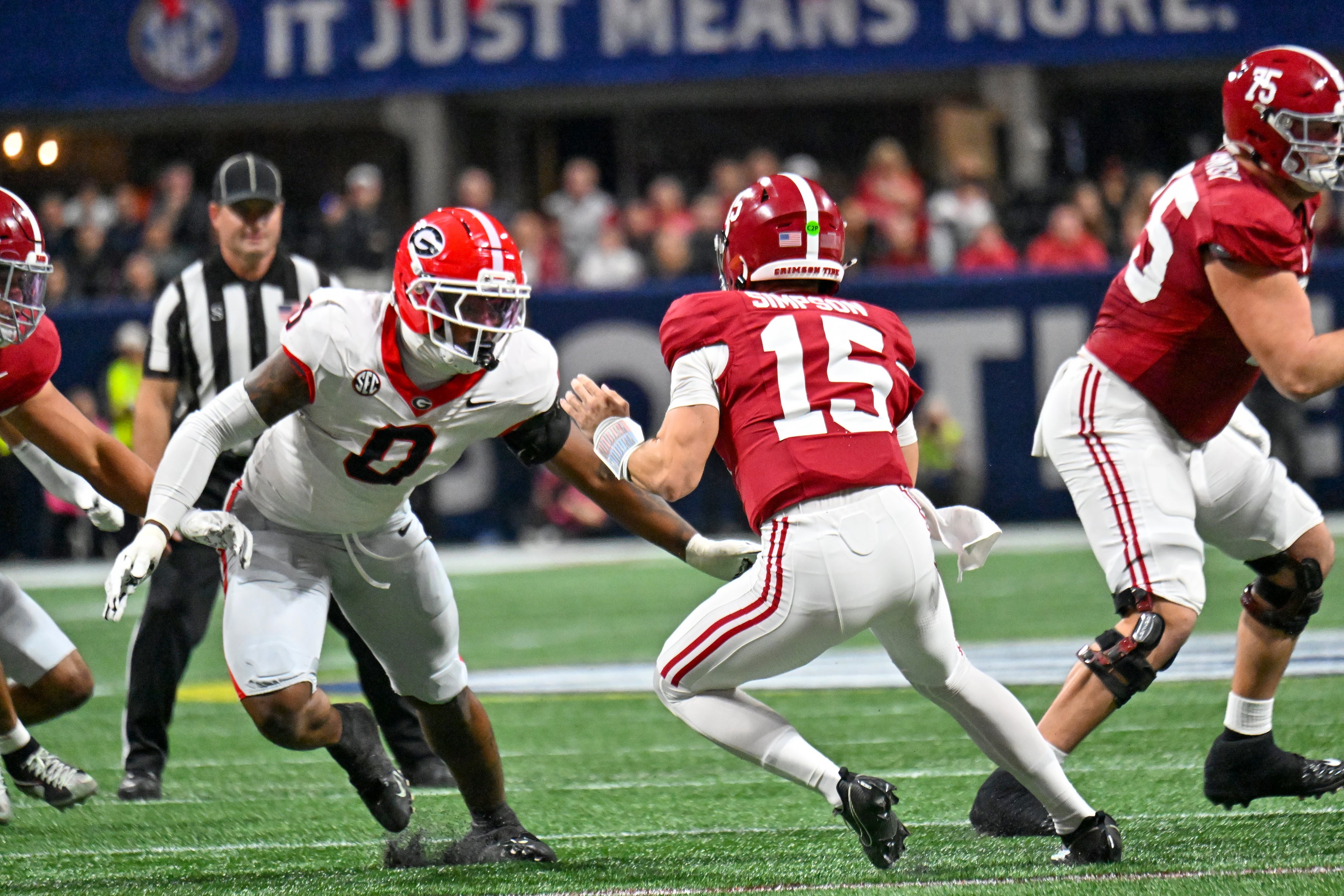 Alabama quarterback Ty Simpson (15) is pressured by Georgia linebacker Gabe Harris Jr. (0) before Simpson is sacked during the first quarter of the SEC Championship game at Mercedes-Benz Stadium, Saturday, Dec. 6, 2025, in Atlanta. (Hyosub Shin / AJC)