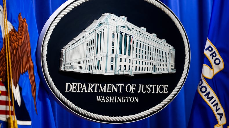 The U.S. Department of Justice logo is before a news conference, Monday, May 4, 2026, in Washington. (AP Photo/Julia Demaree Nikhinson)