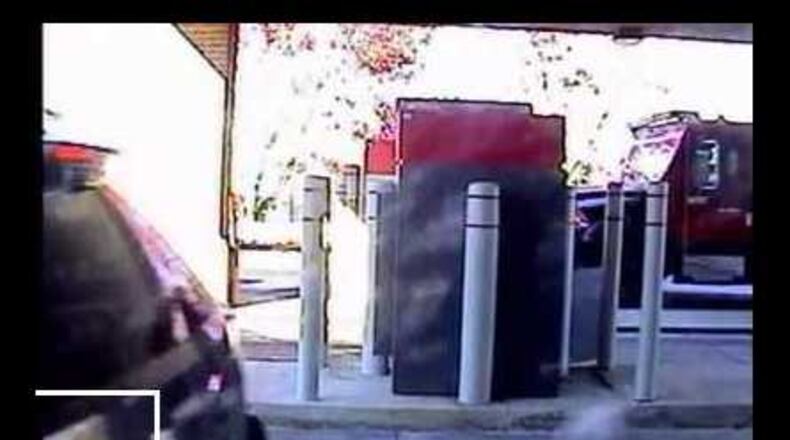 The FBI thinks someone might recognize the car and bumper sticker shown in this security photo from an armored car robbery in DeKalb County.