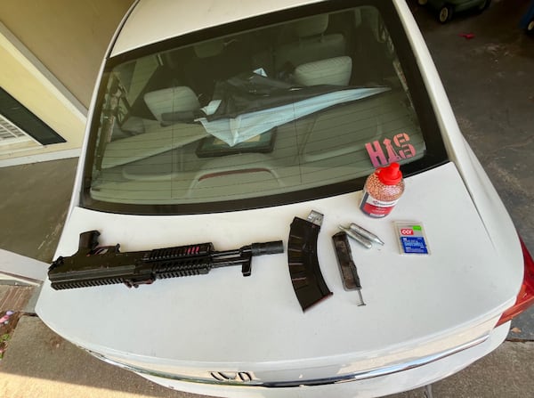 A woman is charged with firing this automatic BB gun at a Gwinnett County Tesla dealership last month, shattering its windows, police said. (Courtesy of Gwinnett County Police Department)