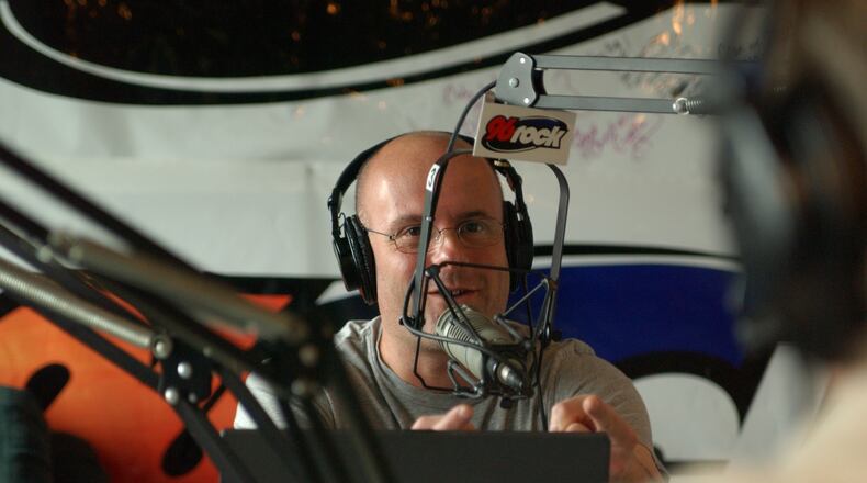 040305 - ATLANTA, GA -- Larry Wachs (cq- bald in grey) and Eric Von Haessler (cq -brown shirt)have been at the helm of 96ROCK for five-plus years and are consistently the top-ranked morning show for men 25-54. With the FCC on the rampage on indecency, we explore why the Regular Guys succeed, skirting the edge but rarely skating over the edge of impropiety. Larry is pictured joking to Eric about the DUI recording they are listening to. (Becky Stein/Special)