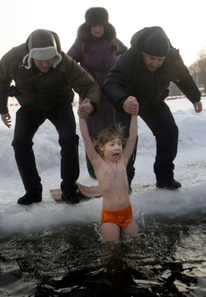 Think it's cold? Russians plunge into ice bath
