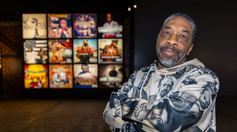 Jasz Smith, owner and operator of Earwax Records, stands in front of one of the exhibitions celebrating Earwax Records and 50 years of hip-hop at the Science Gallery near Pratt-Pullman Yards Saturday, Nov. 11, 2023. (Steve Schaefer/steve.schaefer@ajc.com)