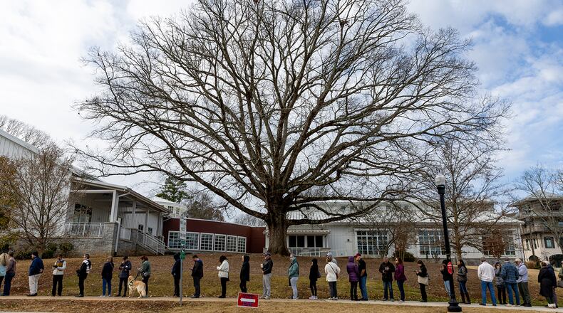 Voters wait in line at Milton Library in Milton on the last day of early voting on Friday, December 2, 2022. (Arvin Temkar / arvin.temkar@ajc.com)