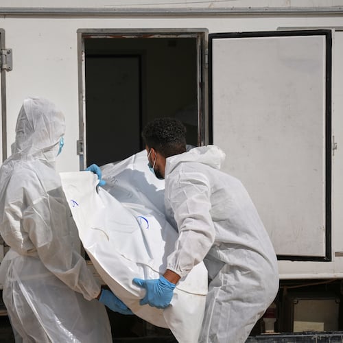 Bodies of unidentified Palestinians returned from Israel are taken into a vehicle to be buried in Nasser Hospital in Khan Younis, Gaza Strip, Friday, Nov. 14, 2025. (AP Photo/Abdel Kareem Hana)