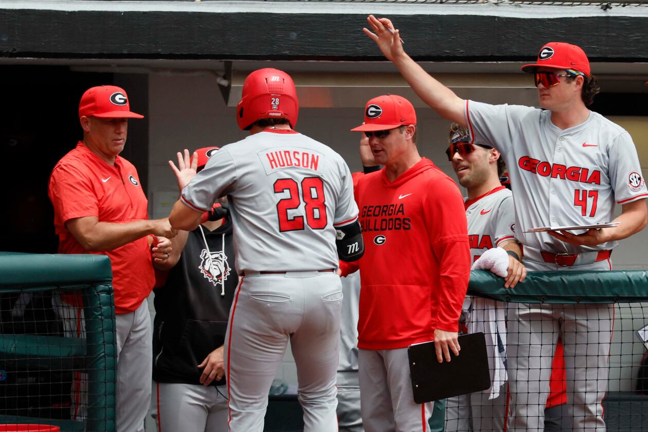 Georgia head coach Wes Johnson (left) gives a fist pump to catcher Brennan Hudson (28) after his solo home run during the third inning of Game 2 of their NCAA Super Regional at Foley Field on Sunday, June 7, 2026, in Athens. (Miguel Martinez/AJC)
