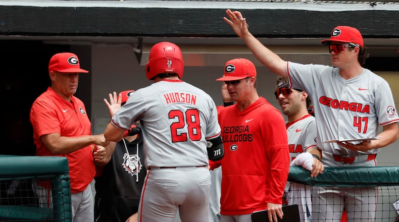 Georgia head coach Wes Johnson (left) gives a fist pump to catcher Brennan Hudson (28) after his solo home run during the third inning of Game 2 of their NCAA Super Regional at Foley Field on Sunday, June 7, 2026, in Athens. (Miguel Martinez/AJC)
