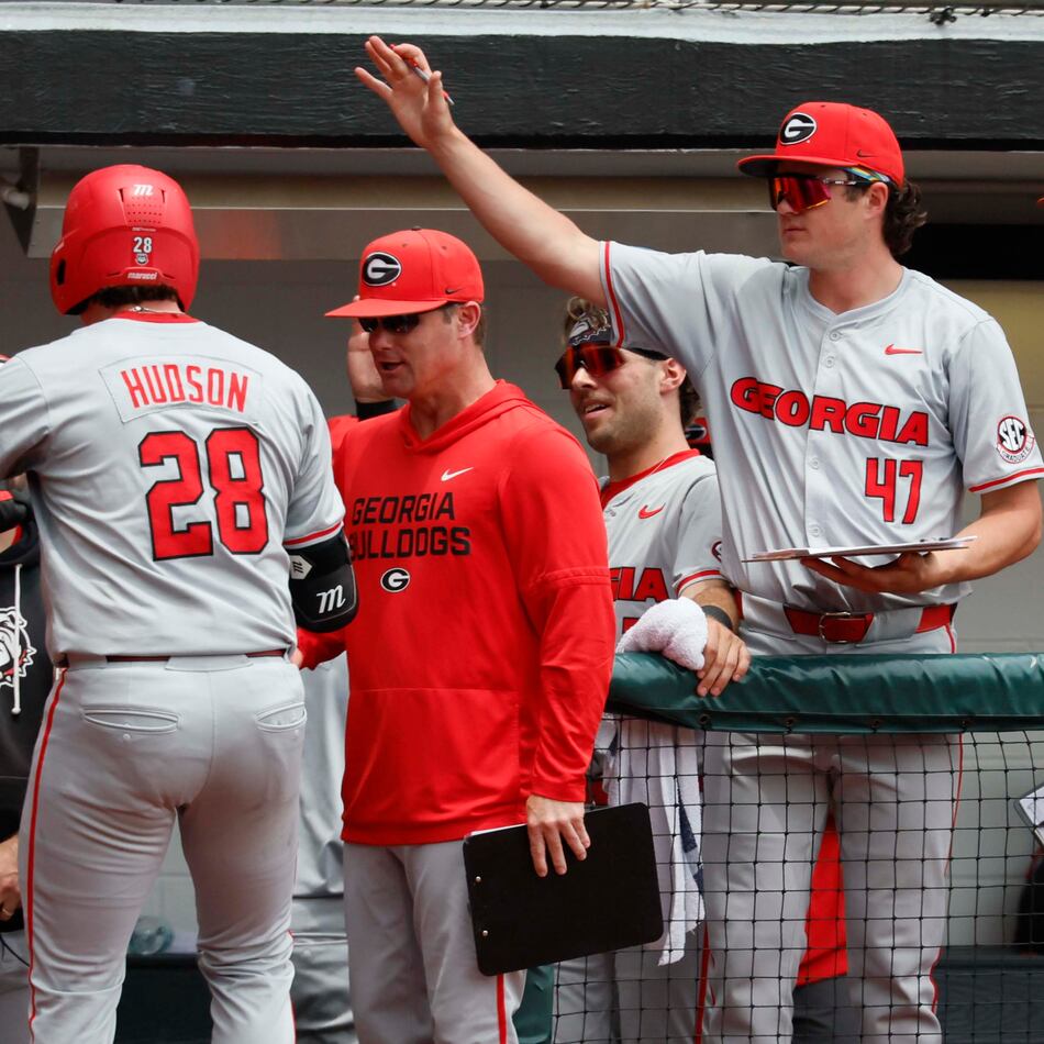 Georgia head coach Wes Johnson (left) gives a fist pump to catcher Brennan Hudson (28) after his solo home run during the third inning of Game 2 of their NCAA Super Regional at Foley Field on Sunday, June 7, 2026, in Athens. (Miguel Martinez/AJC)