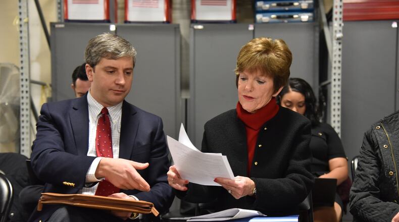 Former mayoral candidate Mary Norwood and her lawyer Vincent Russo (left) confer as they review the recount result at the Fulton County Elections Preparation Center on Dec. 14. HYOSUB SHIN / HSHIN@AJC.COM