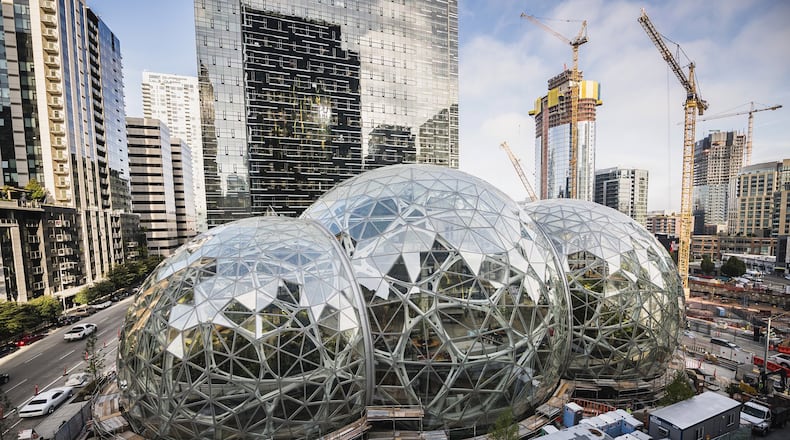 Amazon Tower II rises above the Amazon Biospheres in Seattle. Amazon has been on a building boom in Seattle, but it put a big project there on pause. The company’s reasoning should give a different kind of pause to Georgia, Atlanta and any other locale yearning to land Amazon HQ2, the online giant’s plan for a 50,000-job second headquarters. (Christopher Miller/The New York Times)