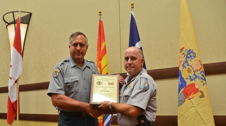 North American Wildlife Enforcement Officers Association Vice President Lew Huddleston (left) presents Georgia Department of Natural Resources Law Enforcement Ranger First Class David Webb with the Officer of the Year Award at the annual conference in Reno, Nevada. (Courtesy Ga. DNR)