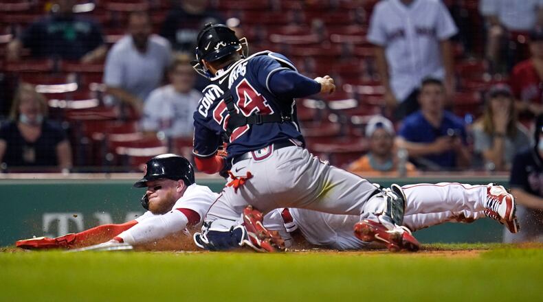 As a Boston Red Sox, Alex Verdugo beat the tag by Braves catcher William Contreras in 2021. On April 18 in Atlanta, he'll be wearing a Braves jersey and batting leadoff. (Charles Krupa / AP)