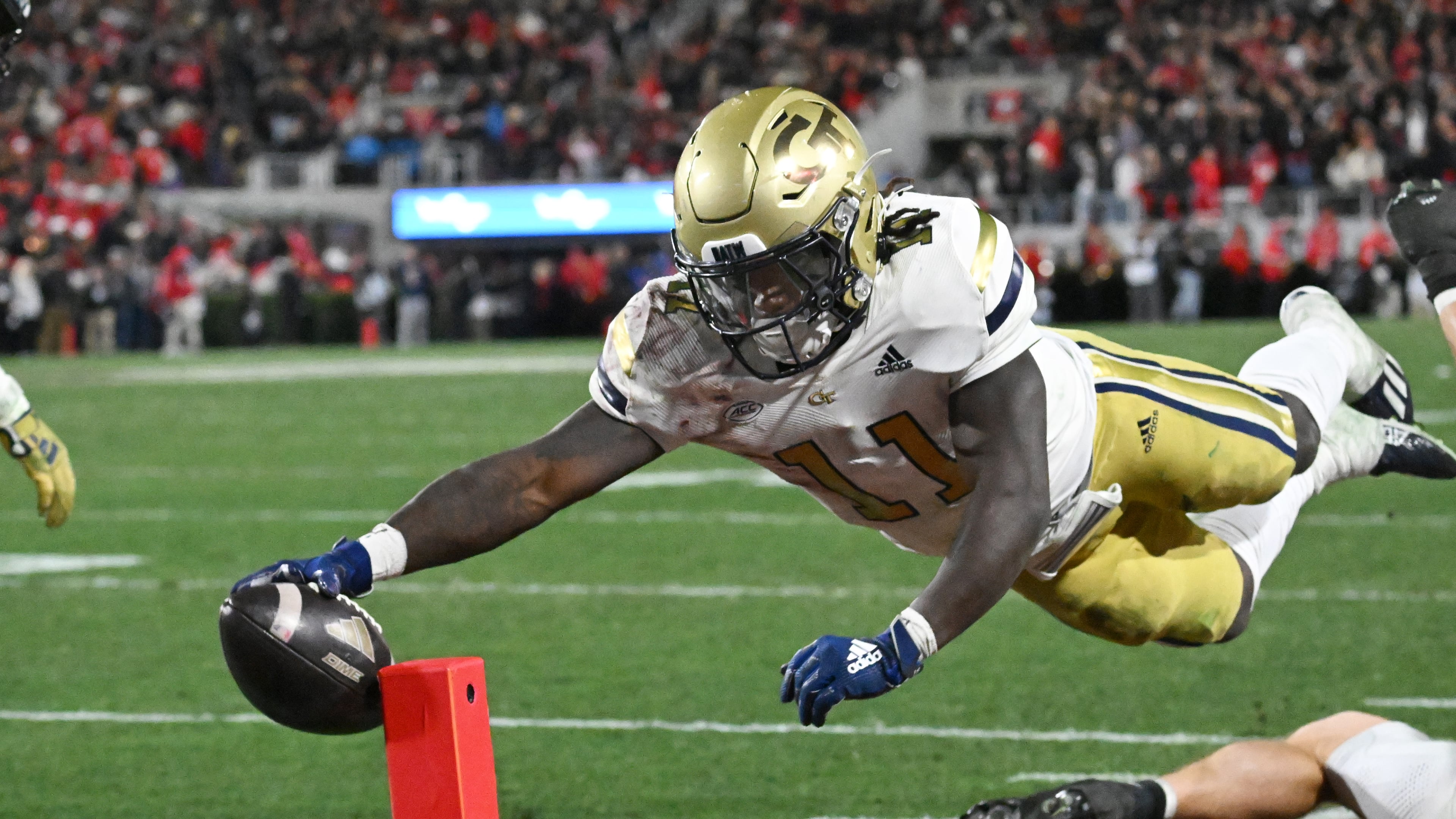 Georgia Tech running back Jamal Haynes, here scoring against Georgia in November, was named to the all-ACC preseason team along with teammate Keylan Rutledge, an offensive lineman. Haynes rushed for 944 yards last season and added 166 yards receiving. (Hyosub Shin/AJC 2024)
