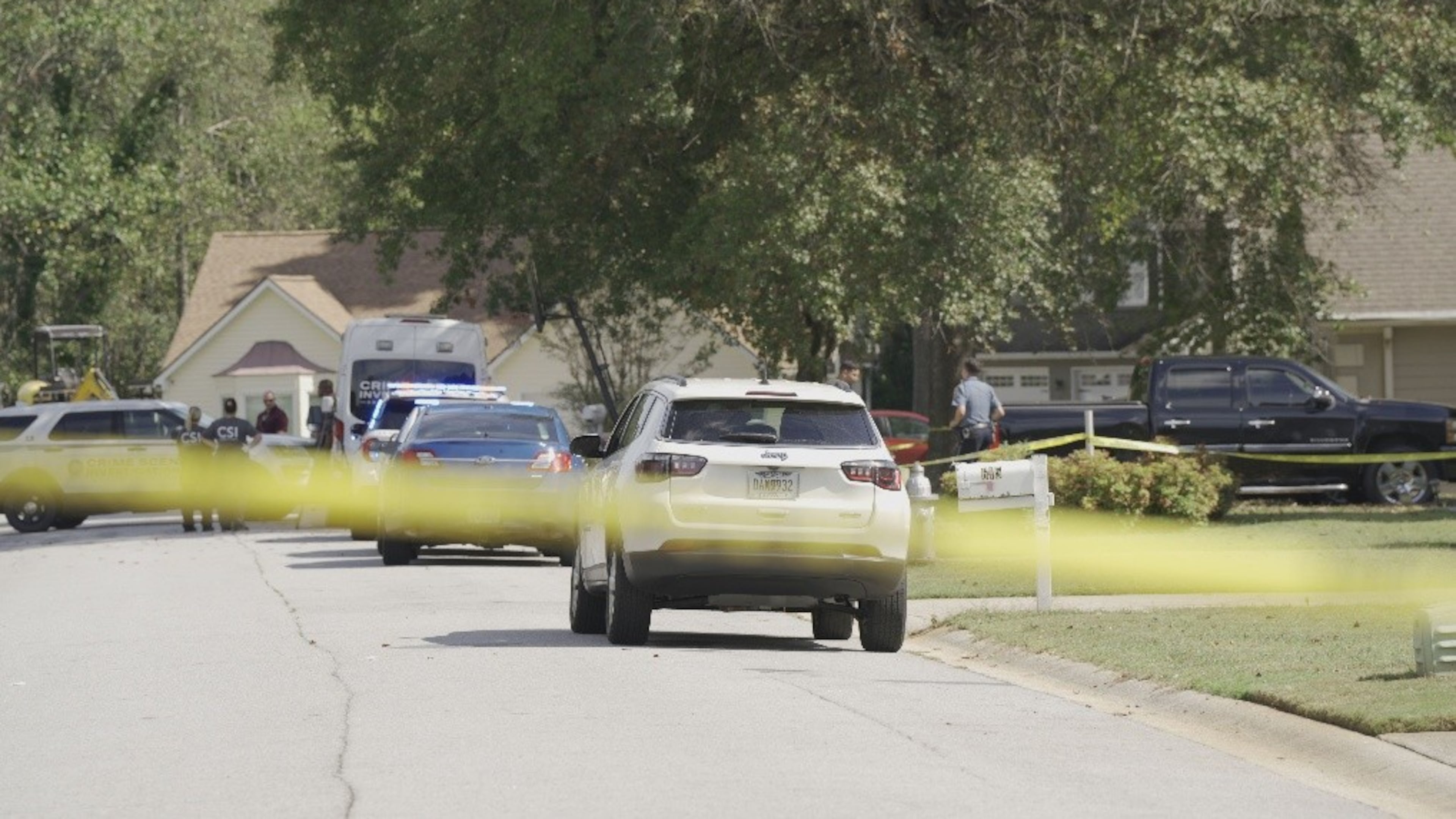 Gwinnett County police investigate after a man and woman were found dead inside a home near the Yellow River on Wednesday. (Courtesy of Gwinnett County Police Department)