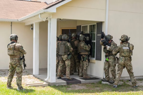 ICE special response team members demonstrate how to break into someone's house at the Brunswick training facility. 