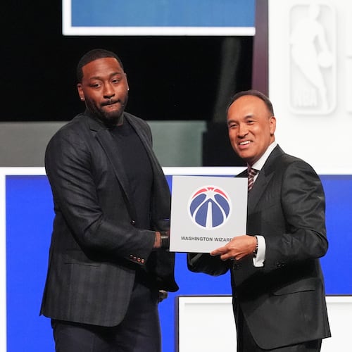 Washington Wizards' John Wall, left, and NBA Deputy Commissioner Mark Tatum, pose for photos after Tatum announced that the Wizards had won the first pick in the NBA basketball draft lottery in Chicago, Sunday, May 10, 2026. (AP Photo/Nam Y. Huh)