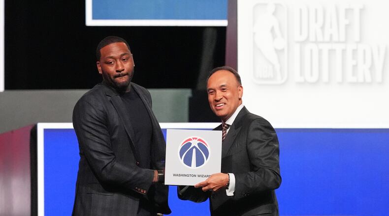Washington Wizards' John Wall, left, and NBA Deputy Commissioner Mark Tatum, pose for photos after Tatum announced that the Wizards had won the first pick in the NBA basketball draft lottery in Chicago, Sunday, May 10, 2026. (AP Photo/Nam Y. Huh)
