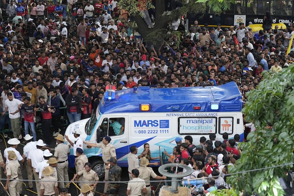 An ambulance arrives at the M. Chinnaswamy Stadium as fans gather to celebrate Royal Challengers Bengaluru cricketers, winners of the Indian Premier League, in Bengaluru, India, Wednesday, June 4, 2025. (AP Photo/Aijaz Rahi)