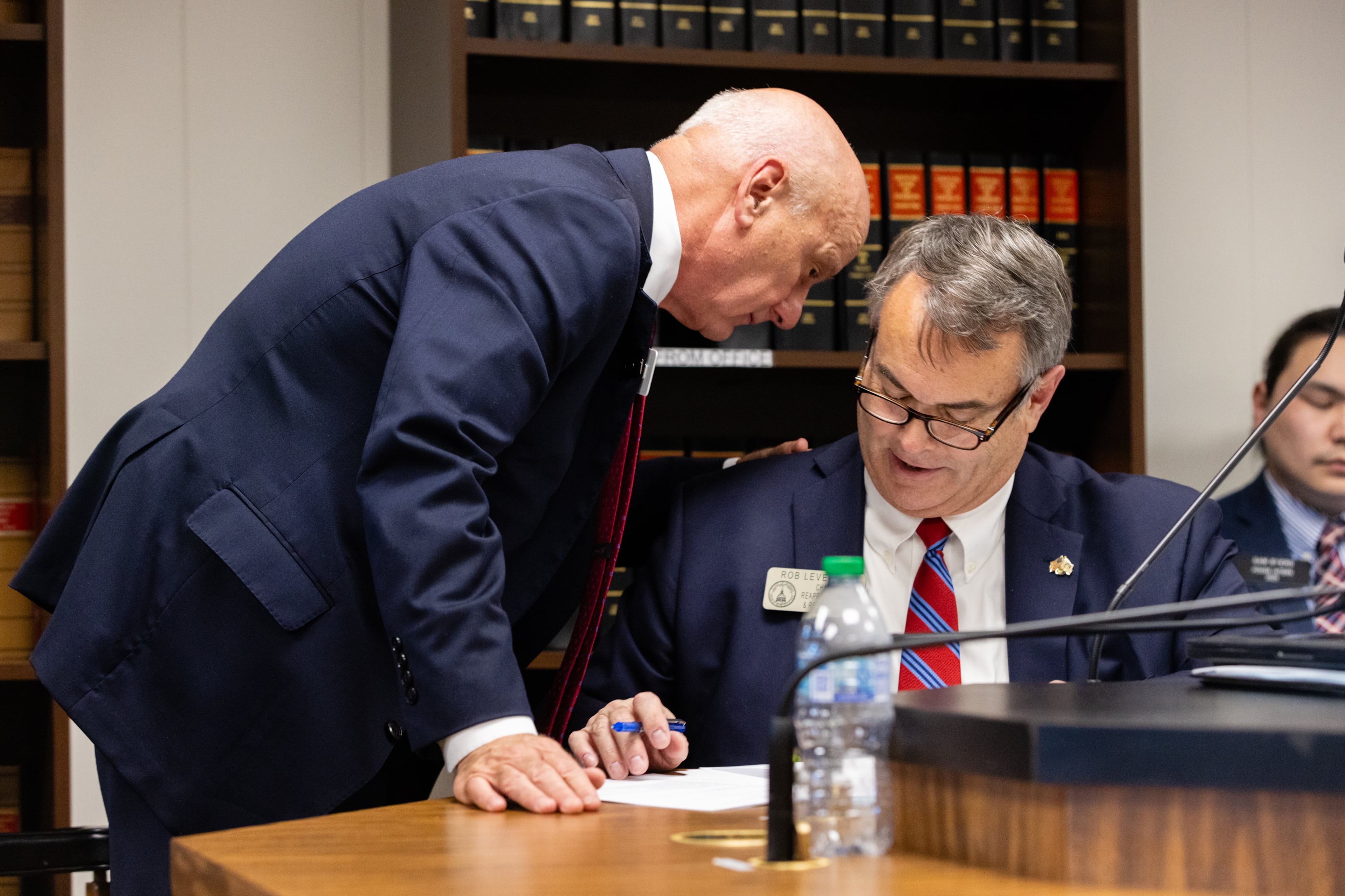Georgia state Sen. Brandon Beach, R-Alpharetta (left), speaks with Rep. Rob Leverett, R-Elberton, after Beach presented SB 244 on March 25. SB 244 would allow President Donald Trump to collect millions in attorneys' fees now that the state's case against him has been dismissed. (Arvin Temkar/AJC)