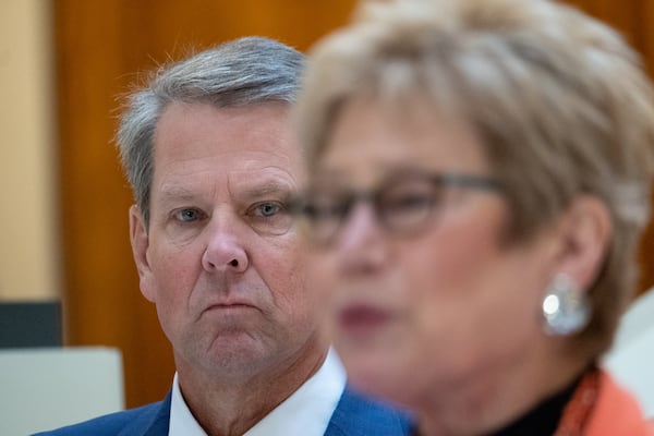 Gov. Brian Kemp listened as Dr. Kathleen Toomey gave an update about the coronavirus in Georgia in 2021.