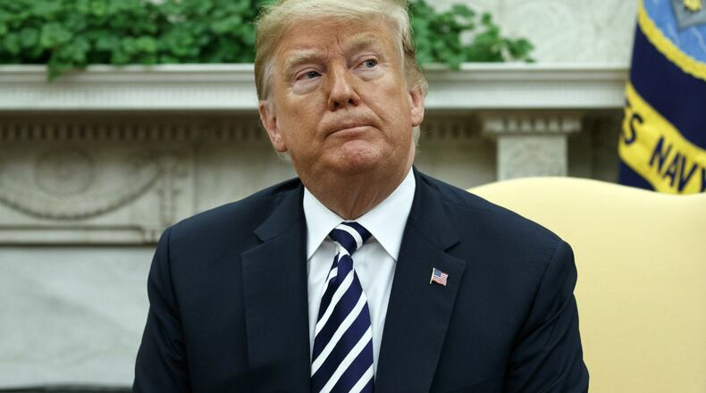 President Donald listens to a question from a reporter during a meeting with Polish President Andrzej Duda in the Oval Office of the White House, Tuesday, Sept. 18, 2018, in Washington.