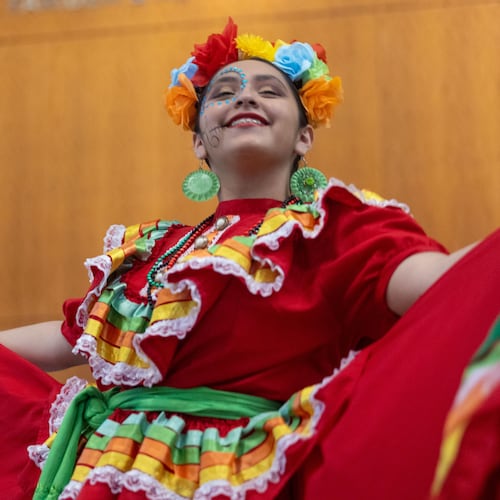 A girl performs a dance at the Atlanta Symphony Orchestra's Dia de Los Muertos Festival at the Woodruff Arts Center in 2022. (Jenn Finch for the AJC)
