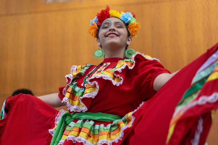 A girl performs a dance at the Atlanta Symphony Orchestra's Dia de Los Muertos Festival at the Woodruff Arts Center in 2022. (Jenn Finch for the AJC)