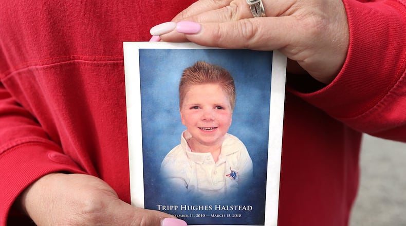 Local resident Delisa Hill, who followed the family on Facebook, holds a program after attending family visitation during the Tripp Halstead Memorial at the Jefferson Civic Center on Sunday, March 18, 2018, in Jefferson. The 7-year-old died Thursday following a traumatic brain injury five years ago from a falling tree limb. Curtis Compton/ccompton@ajc.com