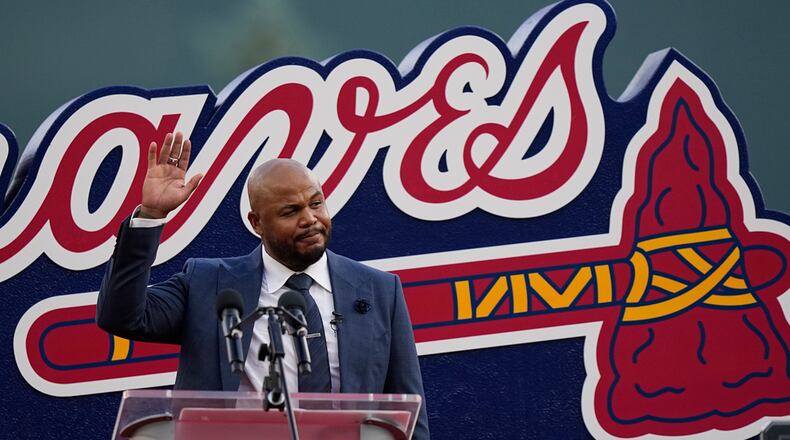 Former Atlanta Braves player, Andruw Jones waves to the crowd as he is honored, Saturday, Sept. 9, 2023, in Atlanta. Jones who won 10 Gold Gloves in a career that began with 12 seasons in Atlanta, became the 11th Braves player or manager to have his number retired on Saturday night. The honor could add momentum to his candidacy for the Baseball Hall of Fame. Jones' 25 was retired before the Braves' game against the Pittsburgh Pirates. (AP Photo/Brynn Anderson)