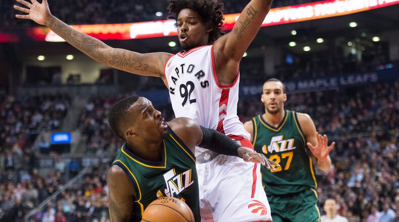 Toronto Raptors center Lucas Nogueira (92) defends against Utah Jazz guard Shelvin Mack (8) during the first half of an NBA basketball game, Wednesday, March 2, 2016 in Toronto. (Nathan Denette/The Canadian Press via AP) MANDATORY CREDIT