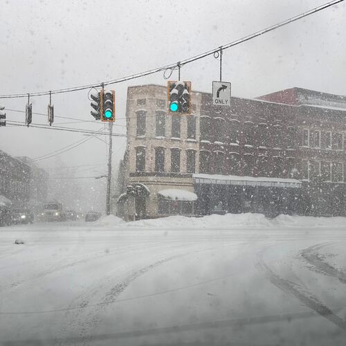 Fresh snow blows through an intersection in Lowville, N.Y., on Thursday, Jan. 22, 2026. (AP Photo/Cara Anna)